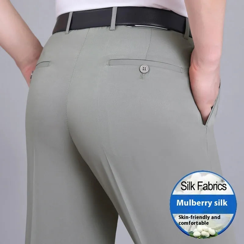 Man wearing black straight-leg high-waisted non-iron business trousers made from a Mulberry Silk blend fabric.