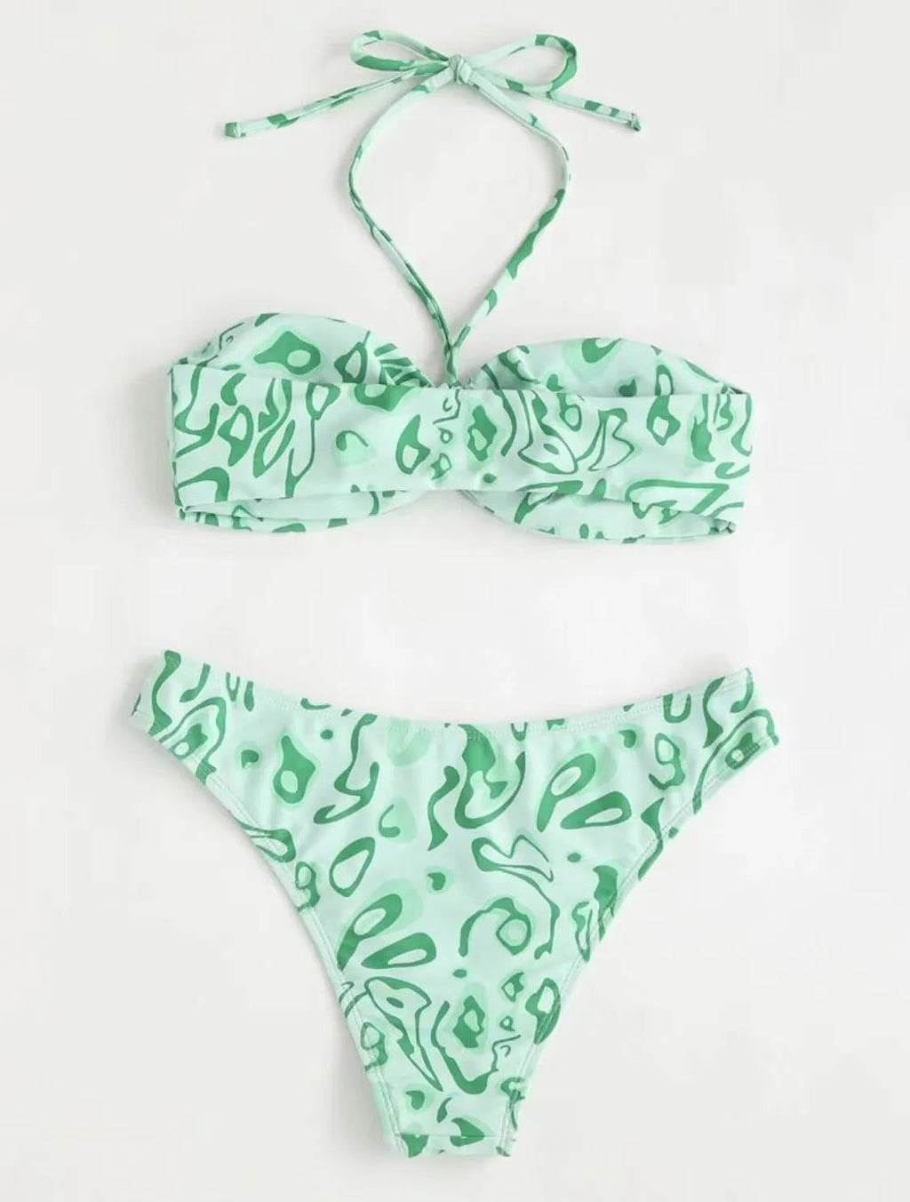 Green floral bandeau bikini swimsuit with split design on a mannequin