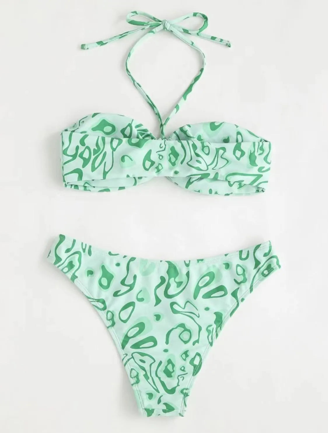 Green floral bandeau bikini swimsuit with split design on a mannequin