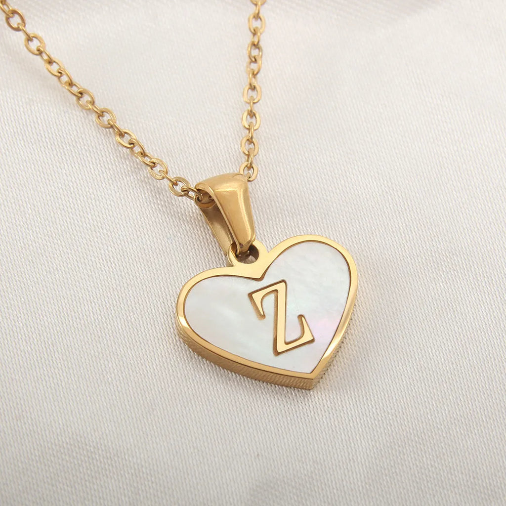 Gold plated heart-shaped white shell pendant personalised initial necklace on a stainless steel chain.