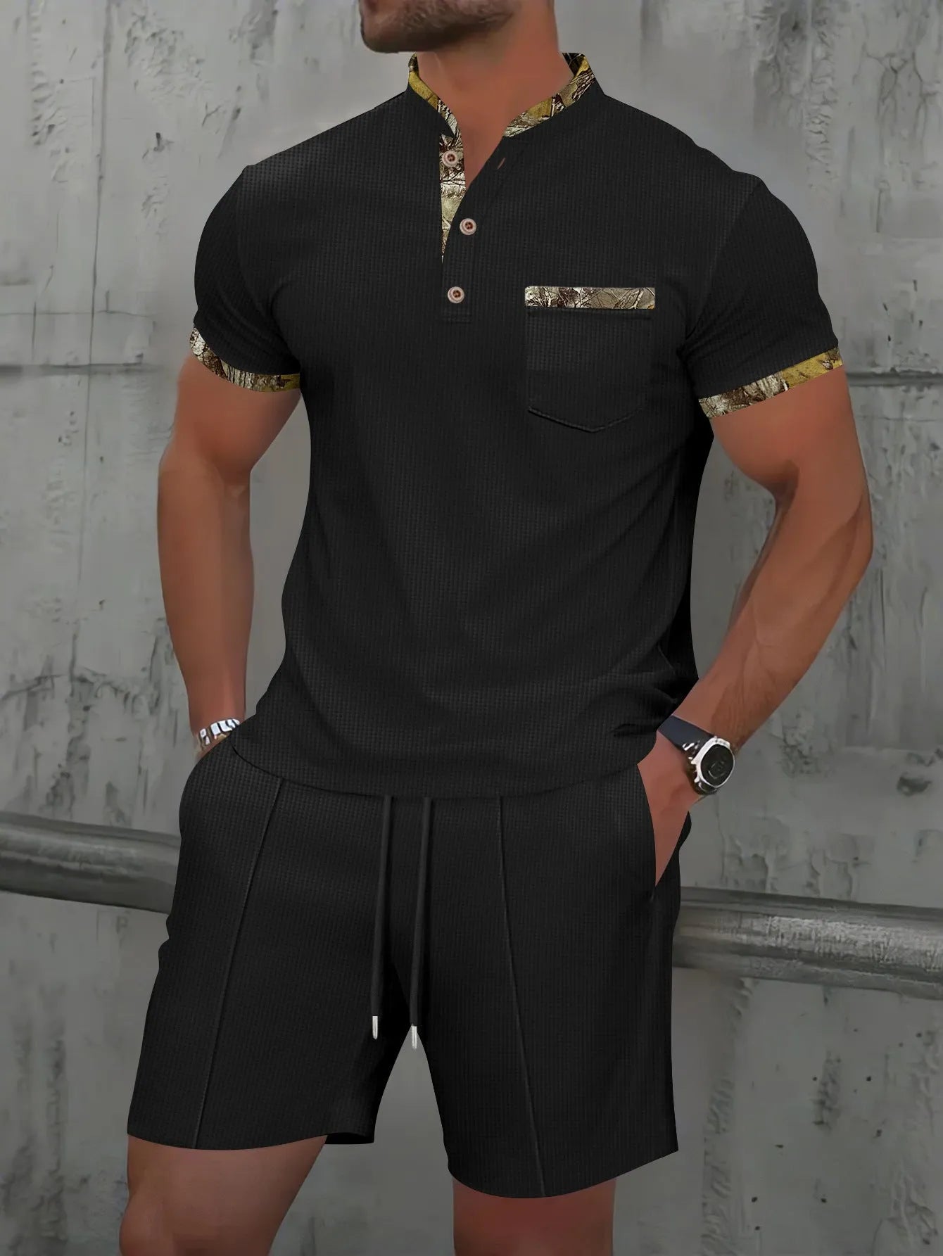 Man wearing a grey waffle knit zip-up polo collar tracksuit with matching shorts for summer leisure.