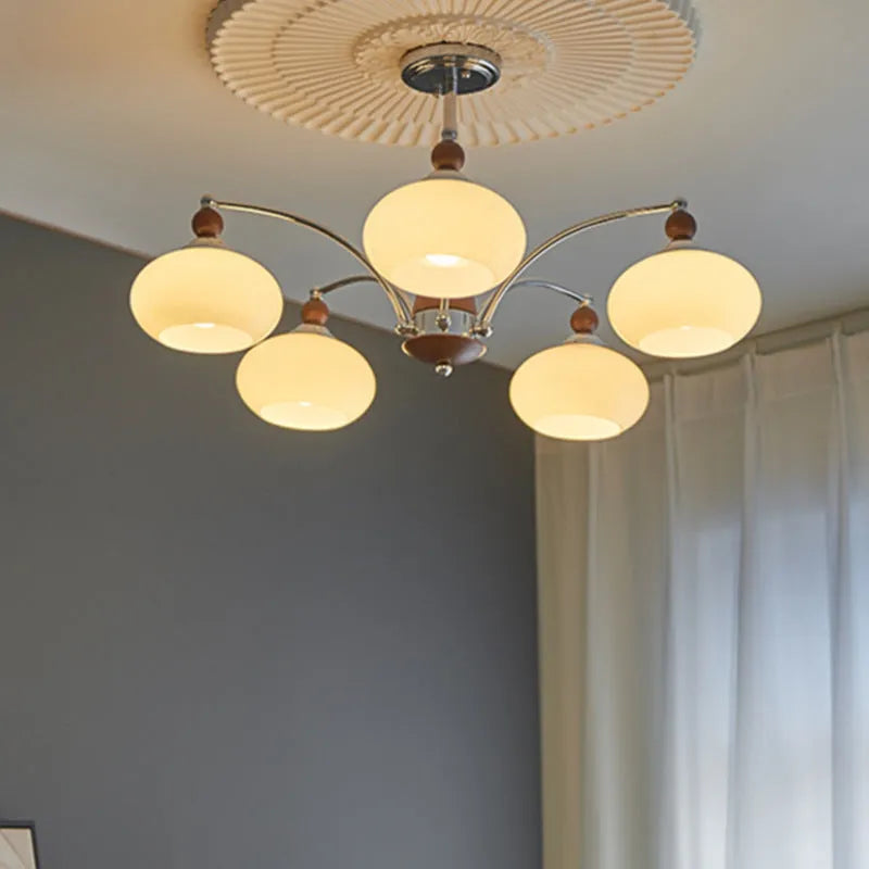 Persimmon glass and chrome chandelier with multiple lampshades in a Middle Ancient style