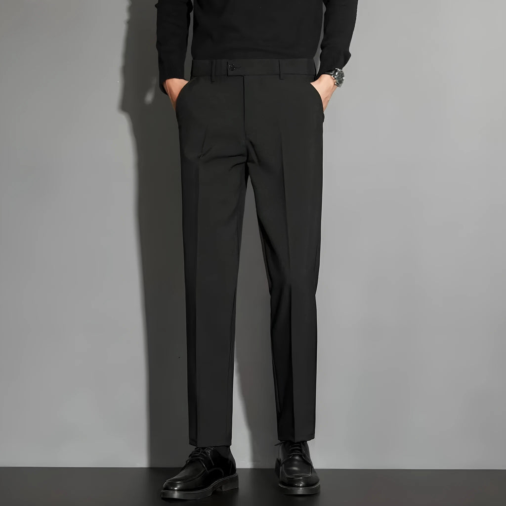 Man wearing straight-leg suit trousers with an ankle-length draping effect in a light colour.