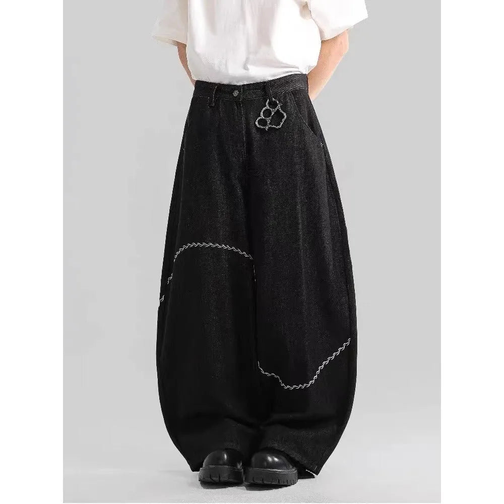 Black straight-leg denim trousers for teenagers on a hanger, showing mid-waist and zip fly detail.