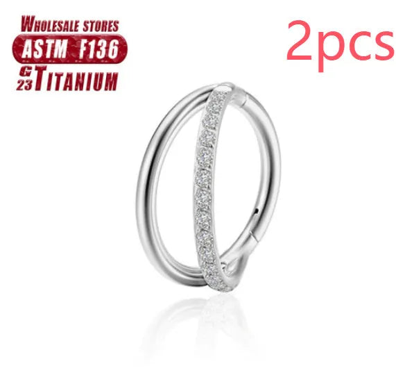Close-up of a titanium alloy fork nose ring in silver, showing the two-prong design on a grey background.