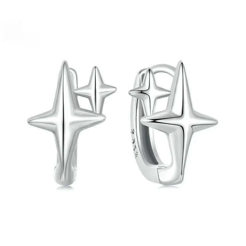 Minimalist sterling silver star ear clips with oxidised finish and ear clip design
