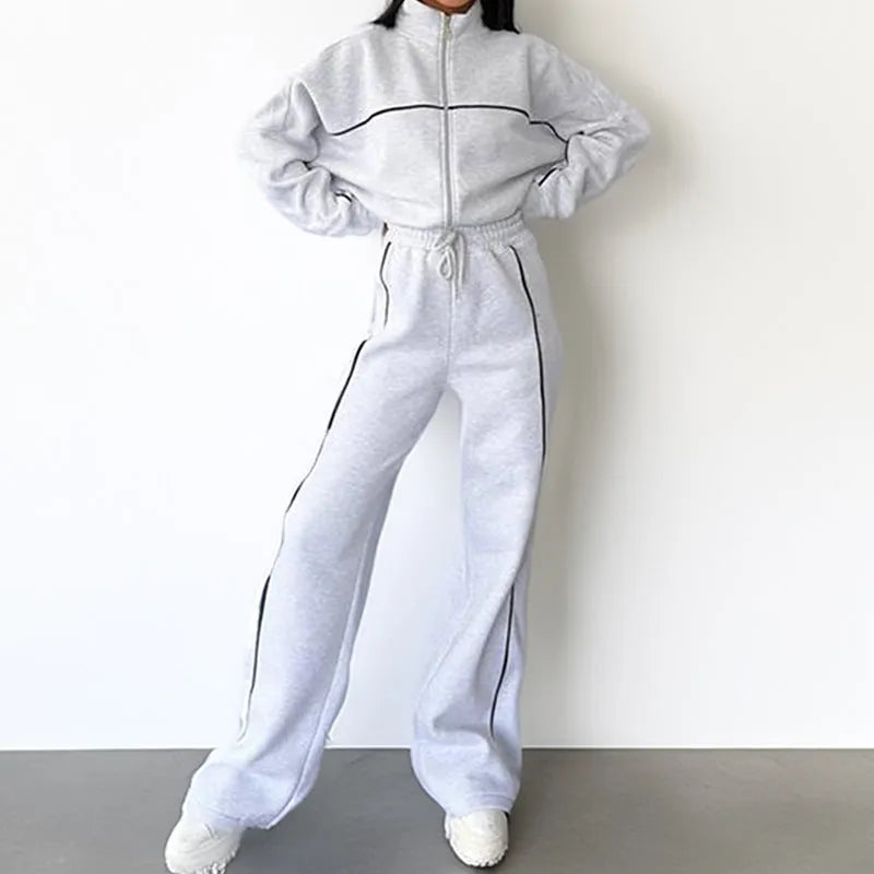 Casual polyester suit set showing a mock neck zip hoodie and matching striped trousers with lace-up detail.