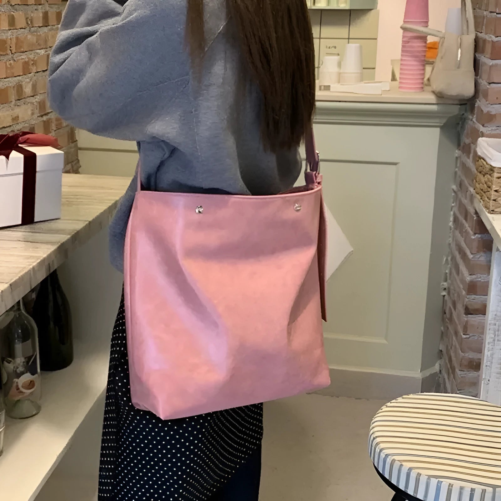 Corduroy one-shoulder commuter bag in pink colour showing textured fabric and structured design