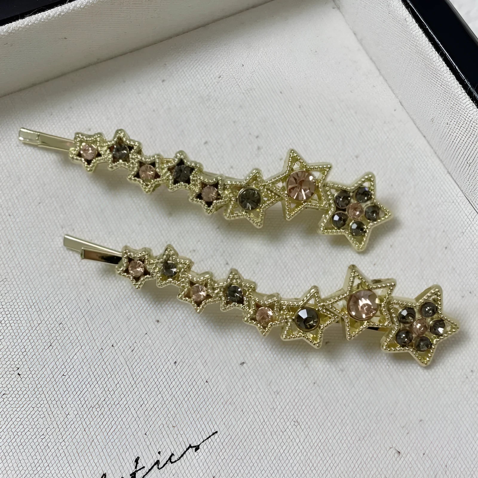 Gold alloy hair barrette with rhinestones and a star charm, shown as a side clip for bangs.