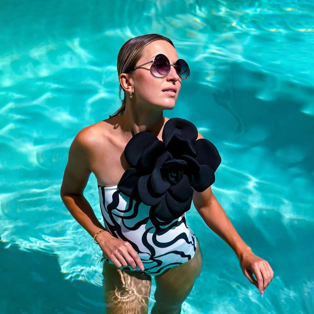 One-piece swimsuit with raised three-dimensional floral pattern in a solid colour, showing a tight European/American style fit.