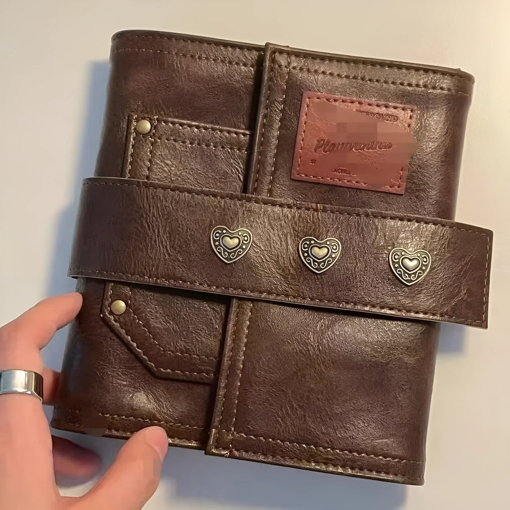 Brown retro notebook with buckle closure showing loose-leaf binding and A7 size