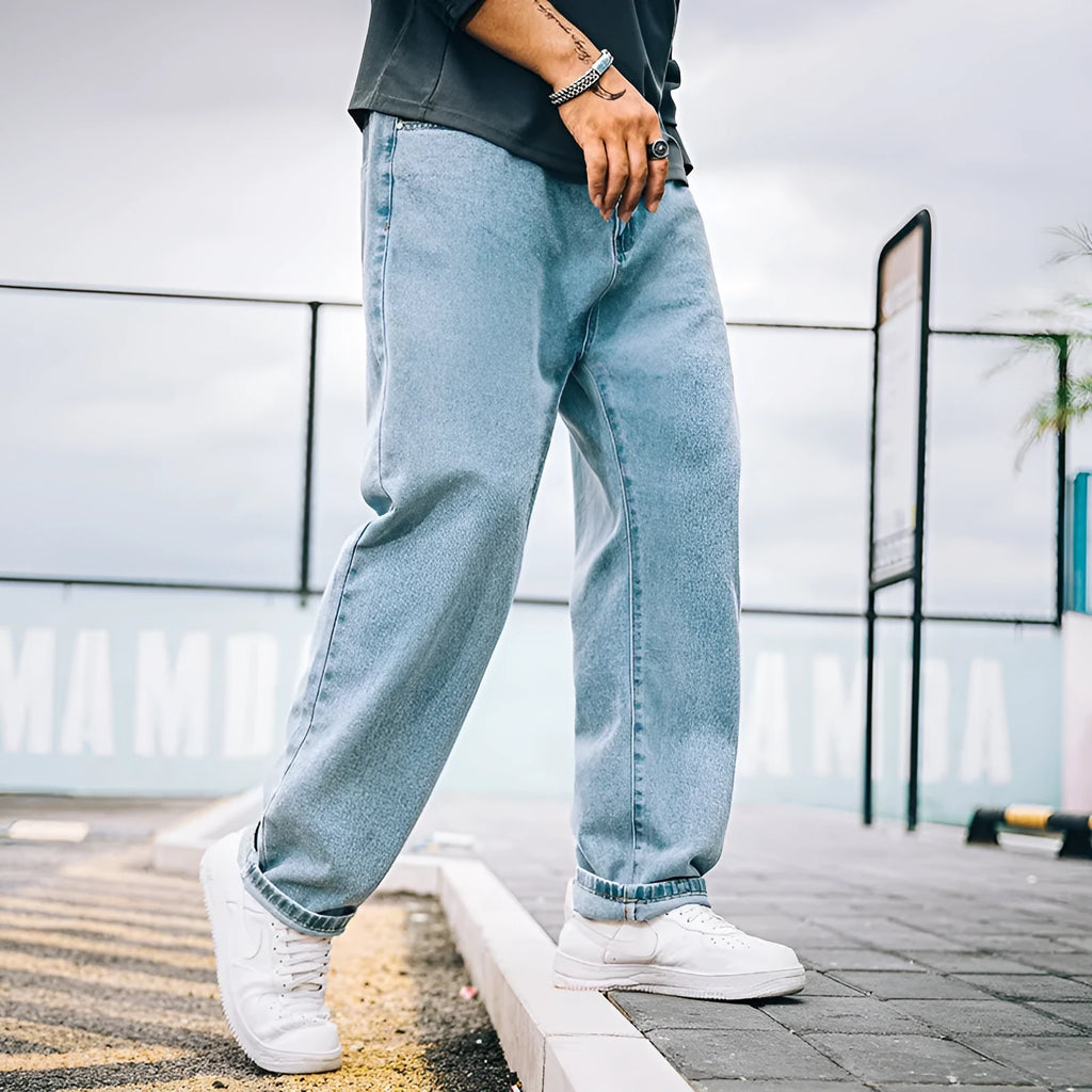 Men's loose straight cotton jeans in dark blue, light blue, and gray with mid-waist zipper fly