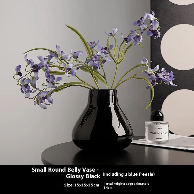 Black ceramic round belly French design vase with two white orchid flowers