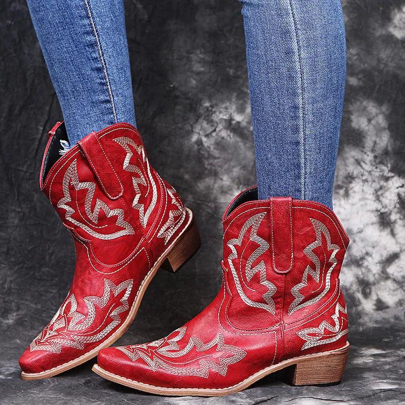 Women's blue embroidered Western cowgirl boots with a low wedge heel and pointed toe.