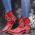 Women's blue embroidered Western cowgirl boots with a low wedge heel and pointed toe.