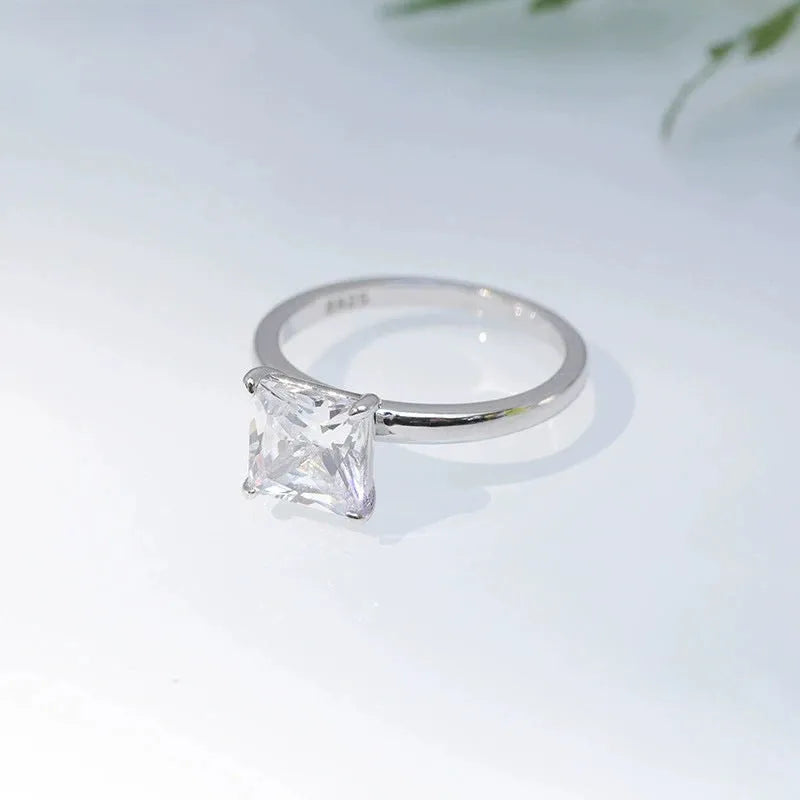 A geometric 925 silver ring with a round zirconium detail, shown in silver, gold, and rose gold finishes.