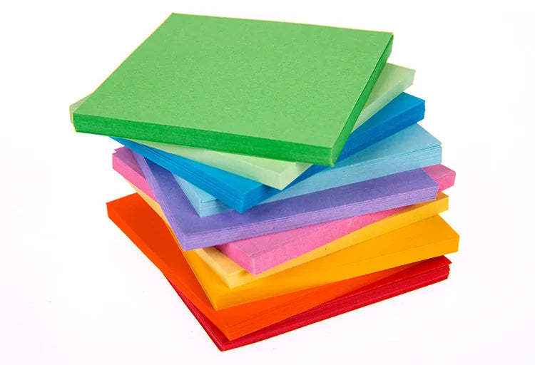 Colourful assortment of miniature rolled paper scrolls with metal eyelets for drift bottle messages.
