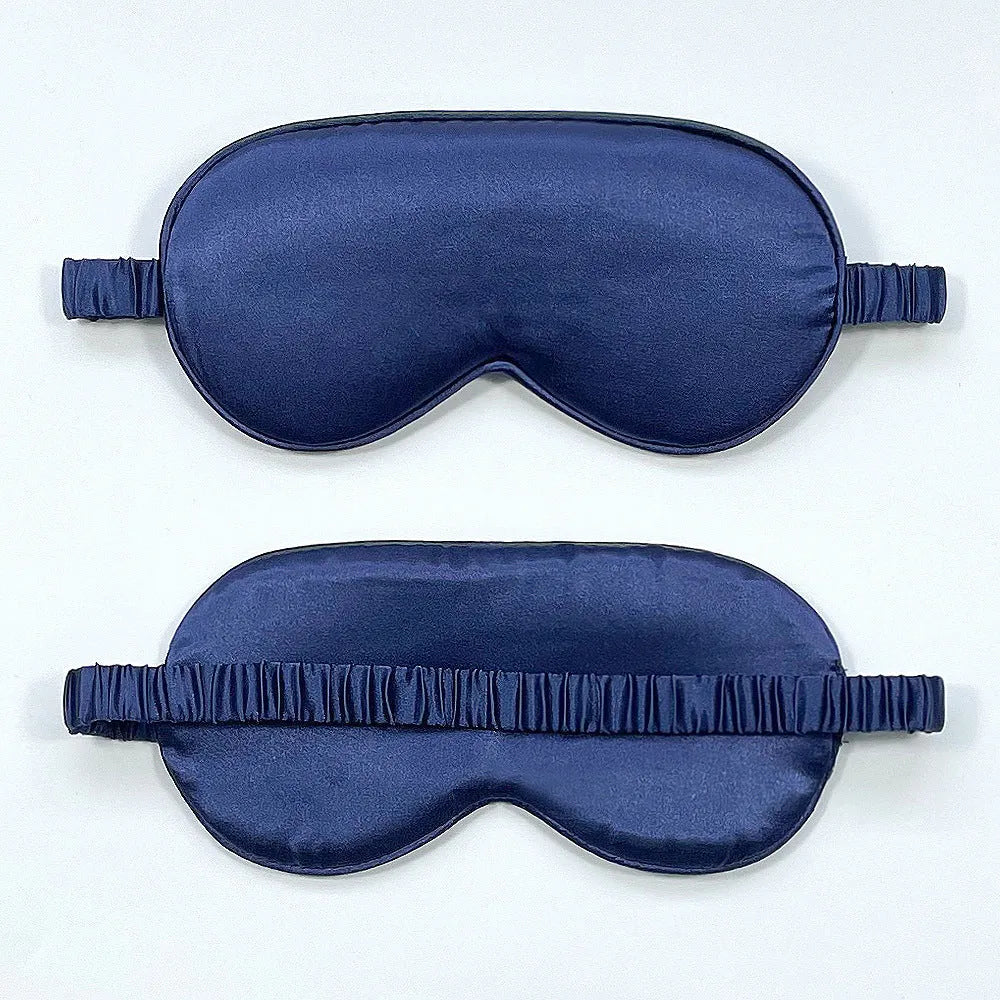 Reversible silk-like sleep eyeshade shown in multiple colour options including sky blue, wine red, and black.
