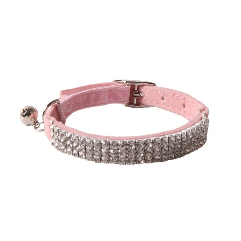 Soft pink flocking cat collar with silver elastic buckle, shown adjusted to fit.