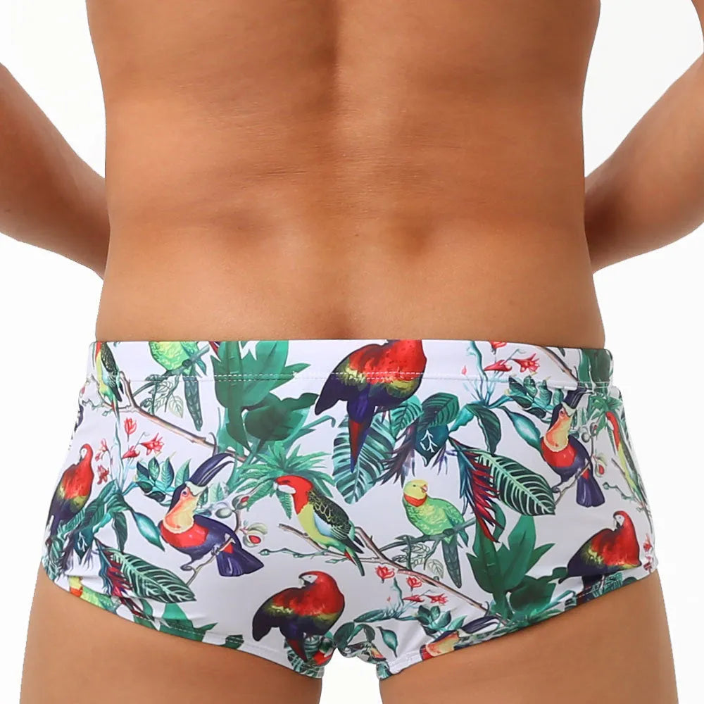 Men's floral and bird print nylon swimming trunks in boxer brief style with cup cover.