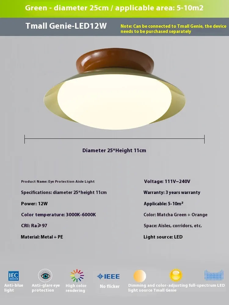 Modern minimalist flying saucer design ceiling lamp in cream yellow on a white ceiling.