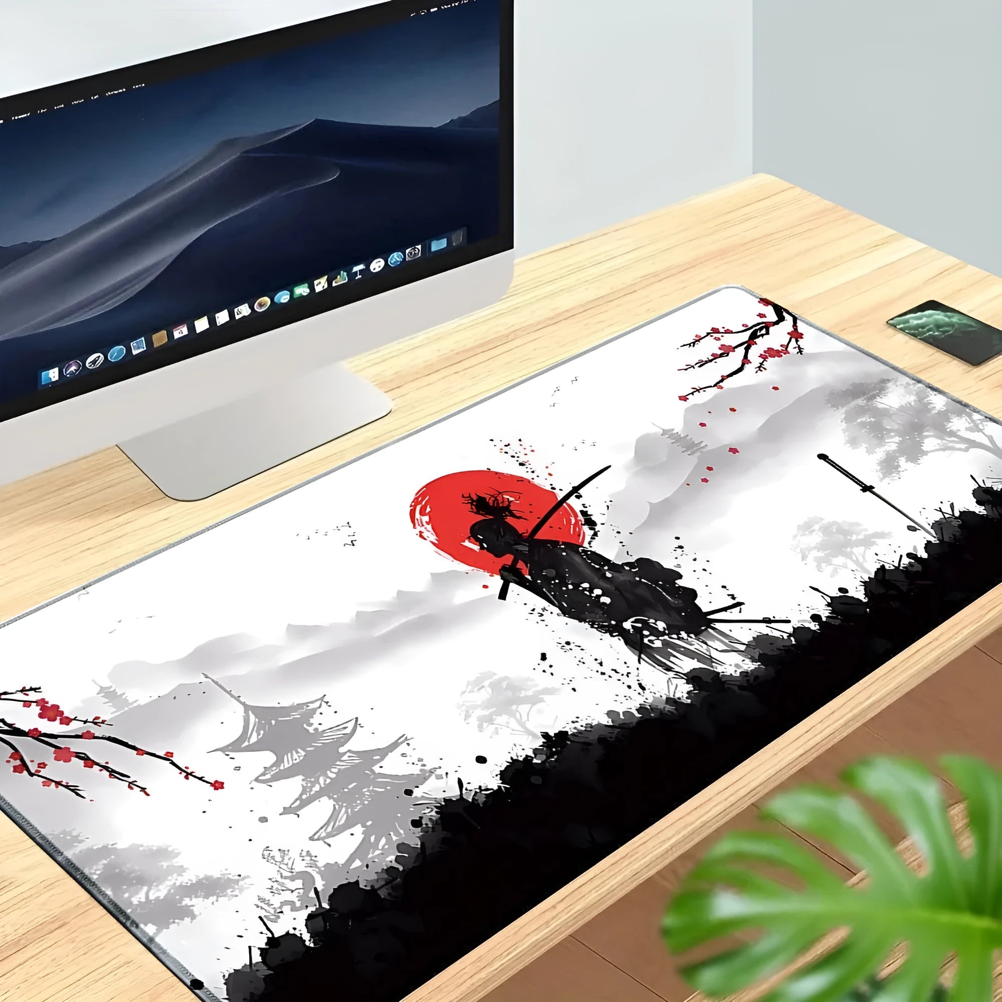 Japanese Samurai design cloth gaming mouse pad with non-slip base on a desk.