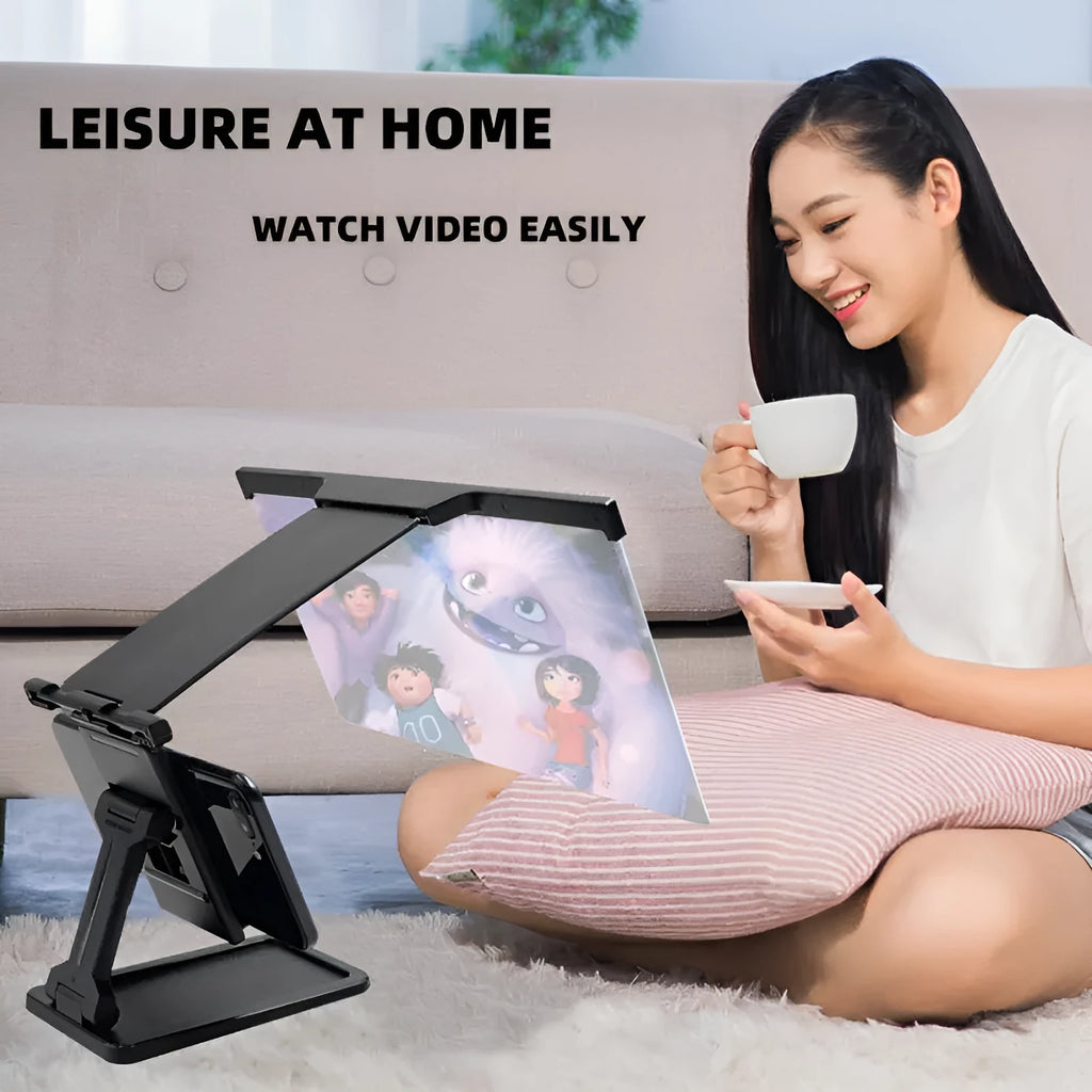 Black folding mobile phone screen magnifier with detachable holder on a desk