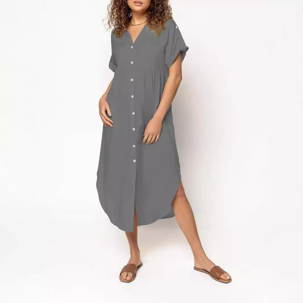 A loose-fitting, solid colour mid-length casual dress with a button-down front and regular sleeves.