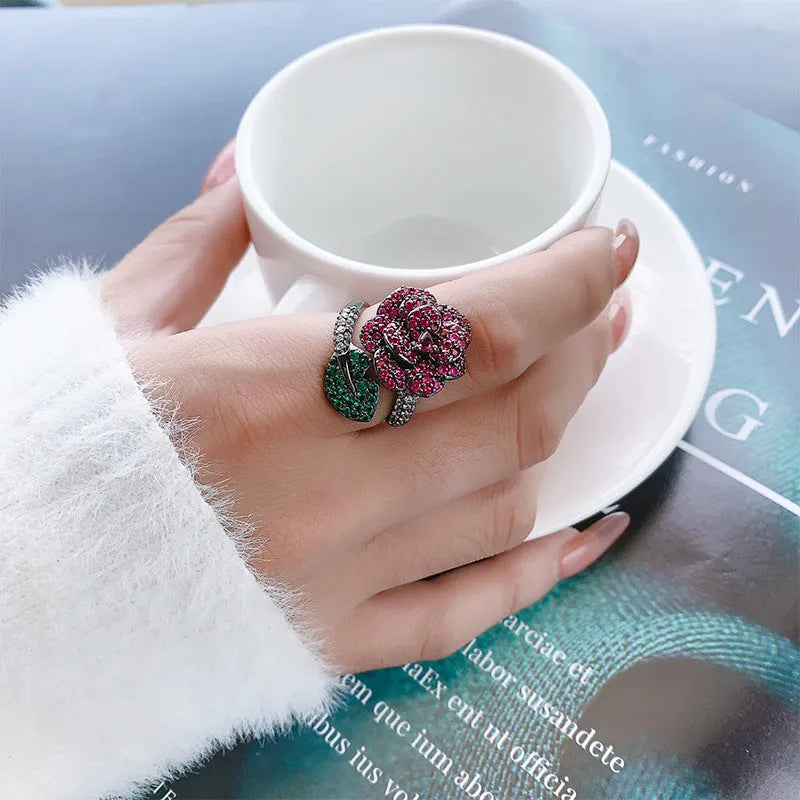 Geometric black gold women's ring with simulated red corundum stones