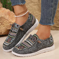 Women's black slip-on flat shoes with round toe and low-top profile on a neutral background.