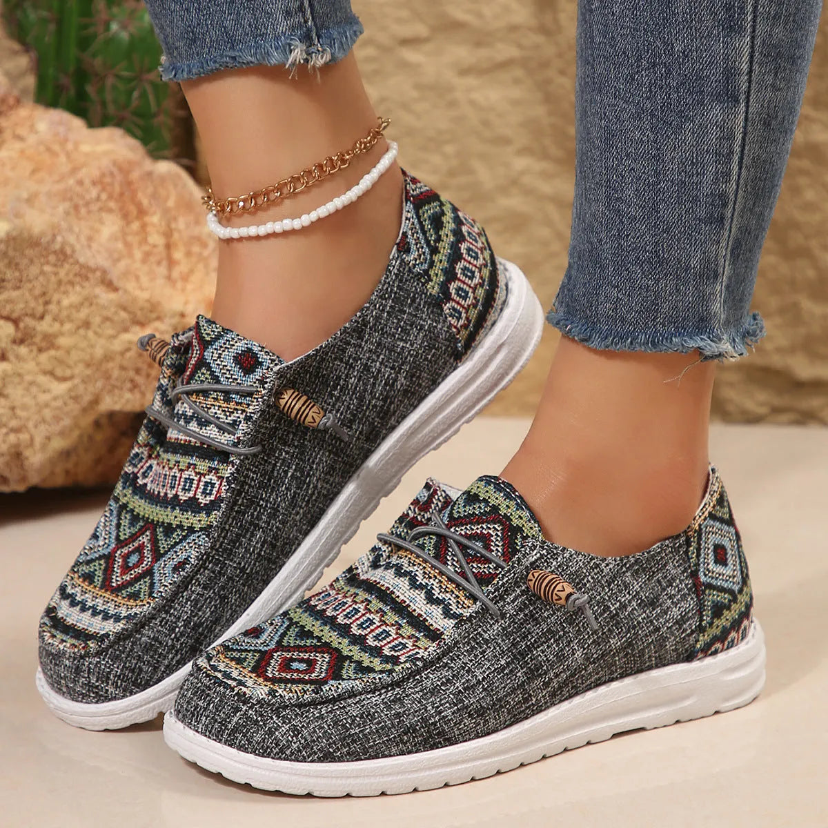 Women's black slip-on flat shoes with round toe and low-top profile on a neutral background.