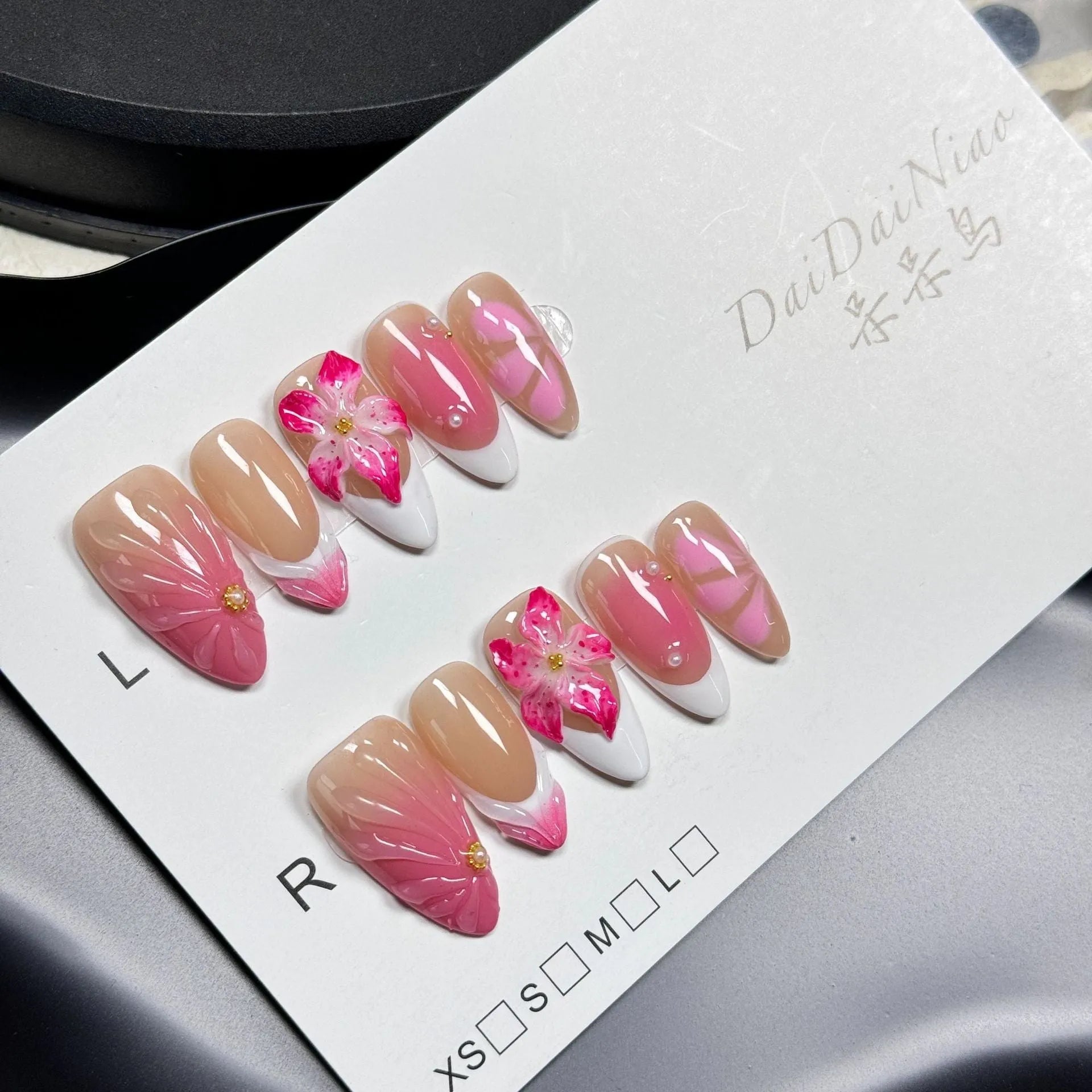 French style artificial nails with three-dimensional fluid ice flower designs on almond-shaped plastic tips