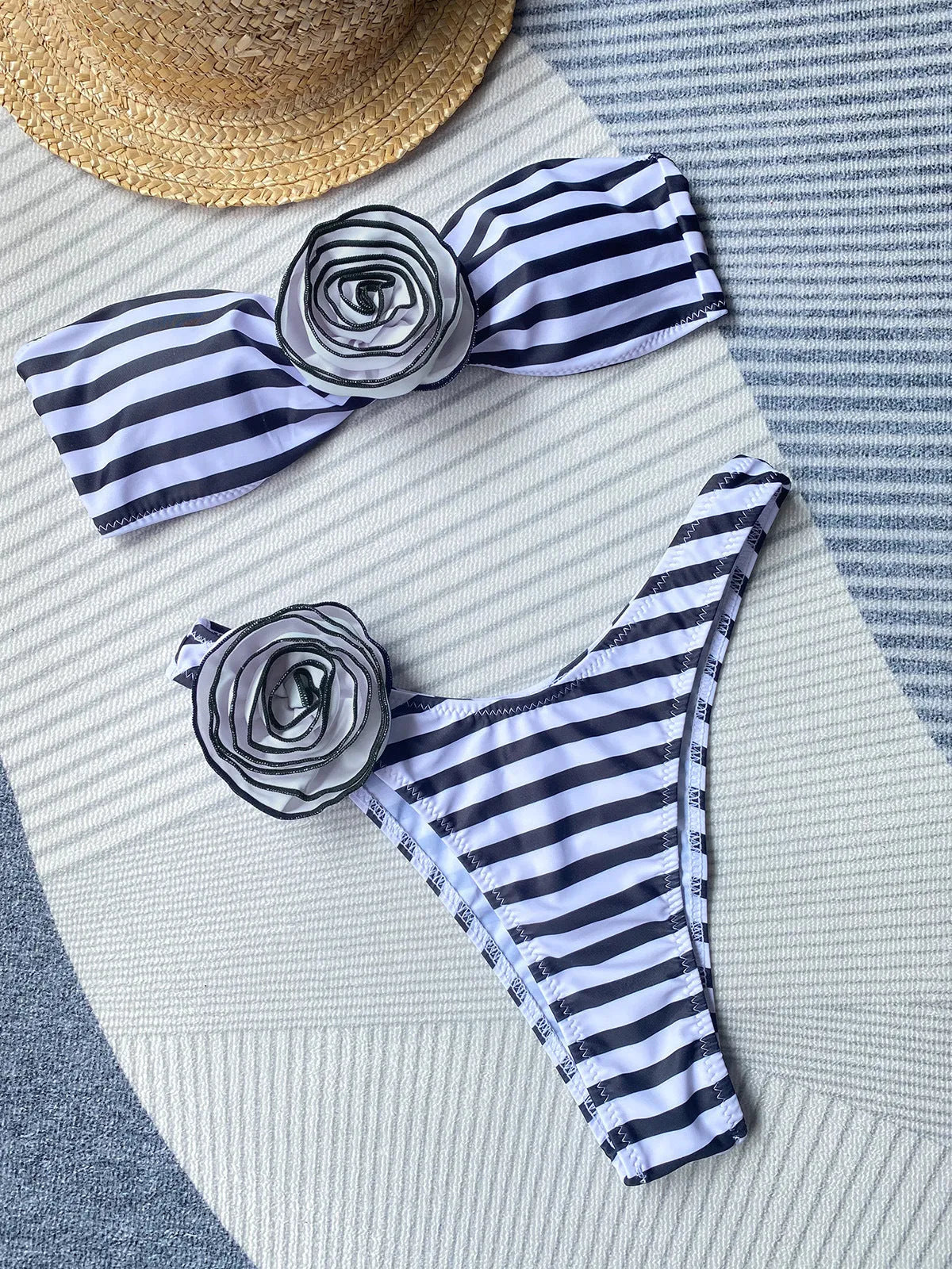 Striped bikini set with floral detail, removable halter tube top, and high-split skirt shorts on a mannequin.