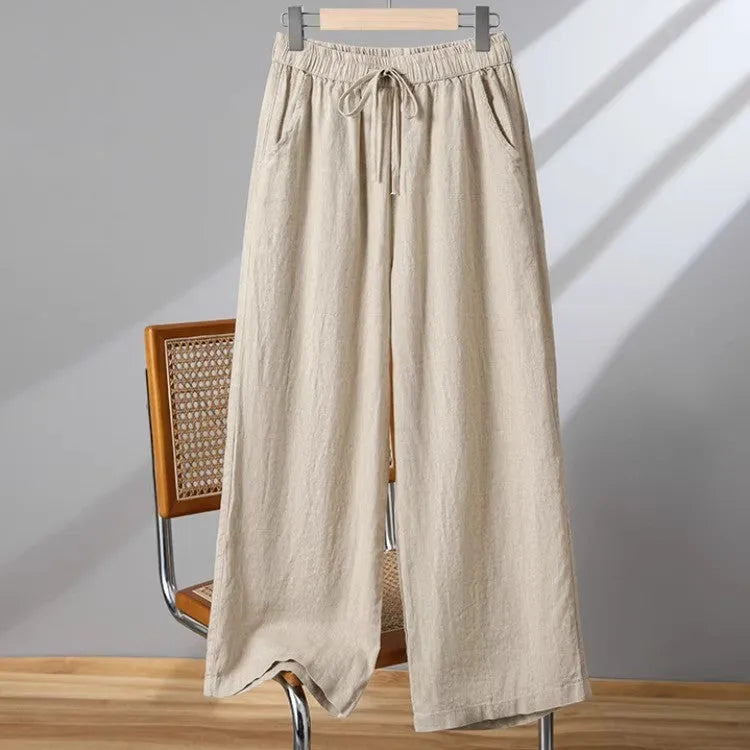 Women's straight leg casual trousers with elastic waist and lace-up drawstring detail in apricot colour.