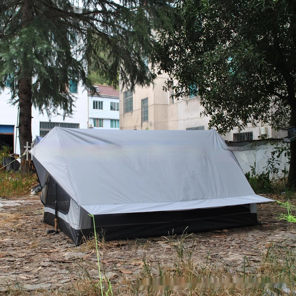 Brown A-line cabin tent pitched with hiking poles as structural support showing spacious interior for 2-3 people