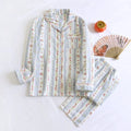 Ladies' red small fruit print cotton gauze long-sleeved top and matching trousers homewear set laid flat.