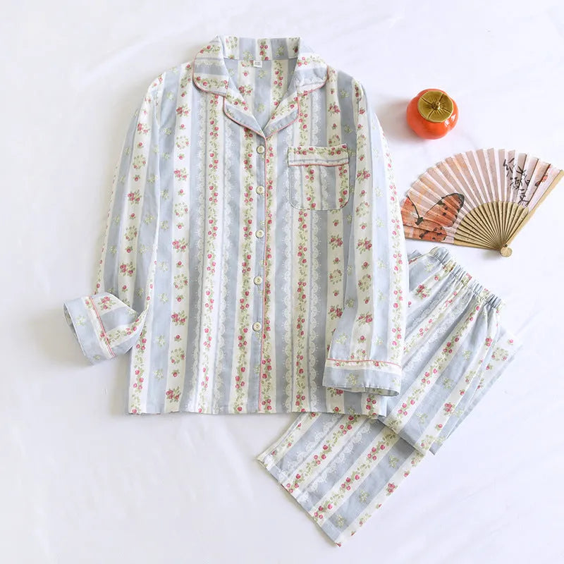 Ladies' red small fruit print cotton gauze long-sleeved top and matching trousers homewear set laid flat.