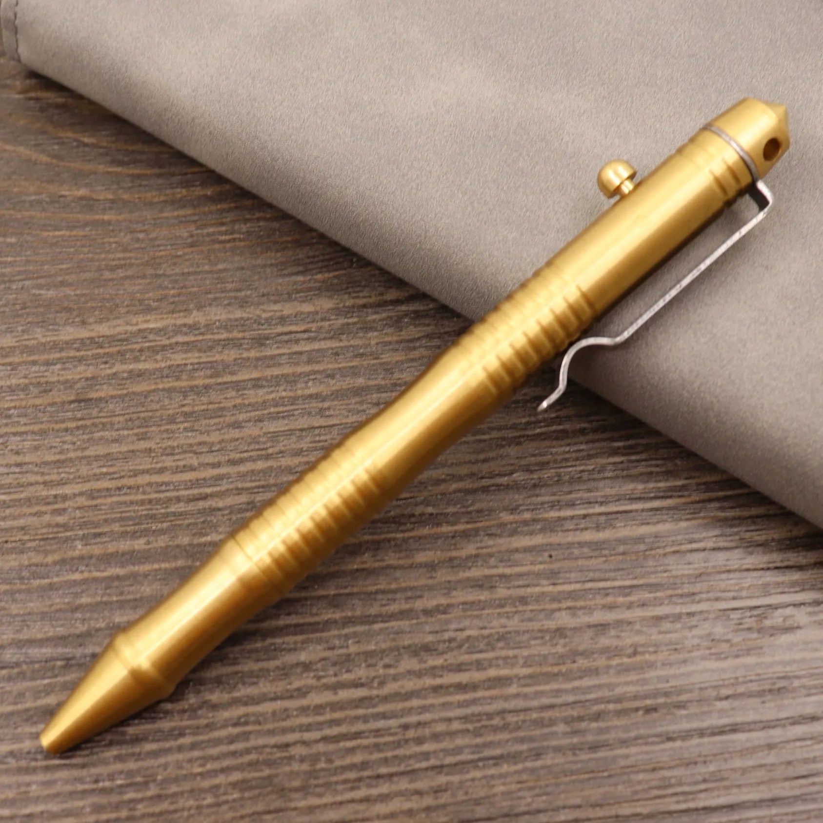 Retro brass tactical pen with bolt action mechanism in brushed natural finish