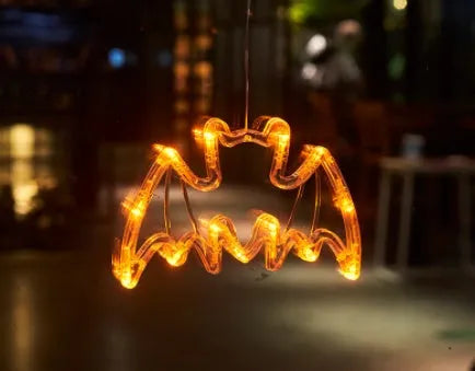 Set of seven battery-powered Halloween LED hanging lights with ghost, spider, and pumpkin designs for window decoration.