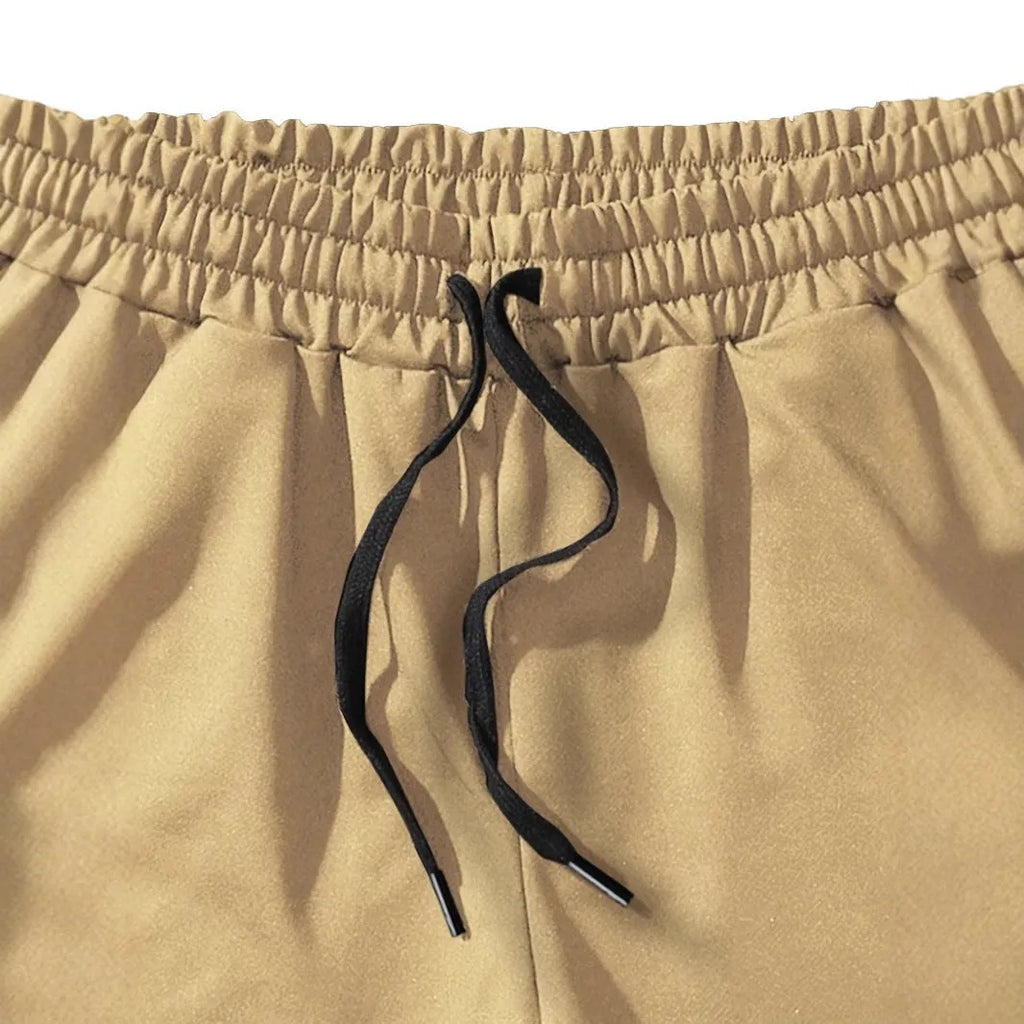 Men's khaki coconut print sports shorts with elastic waistband and straight leg cut
