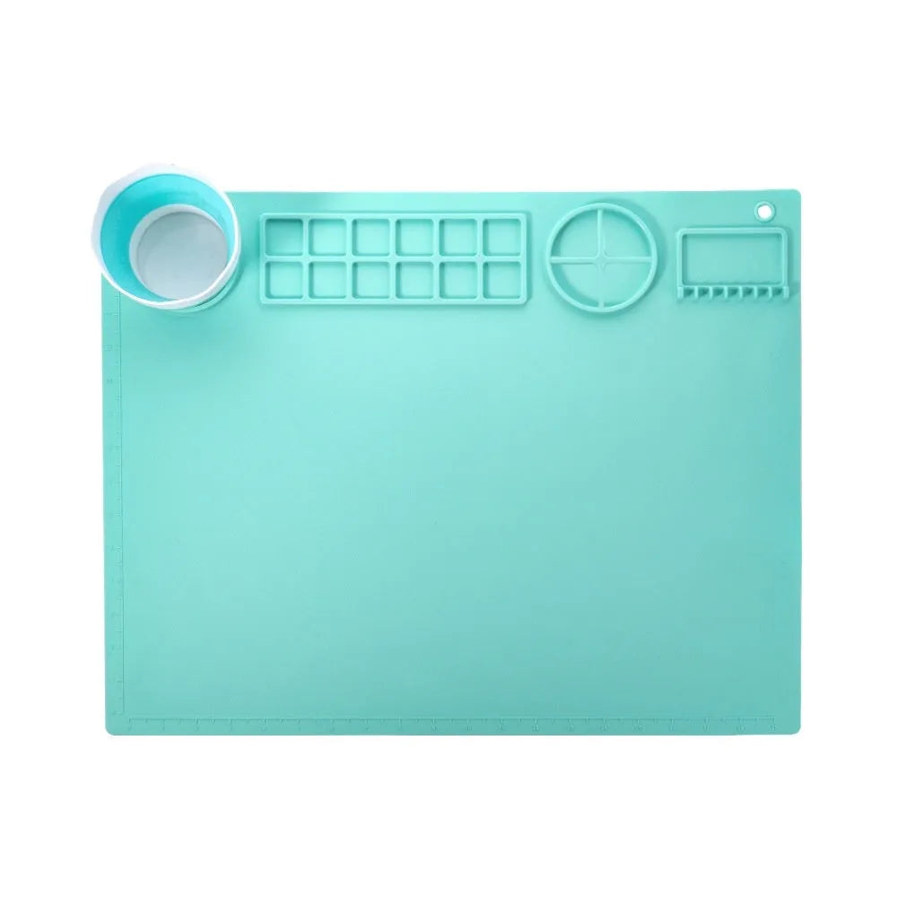 Green silicone painting mat measuring 50x40cm with two round paint mixing bowls on the surface.