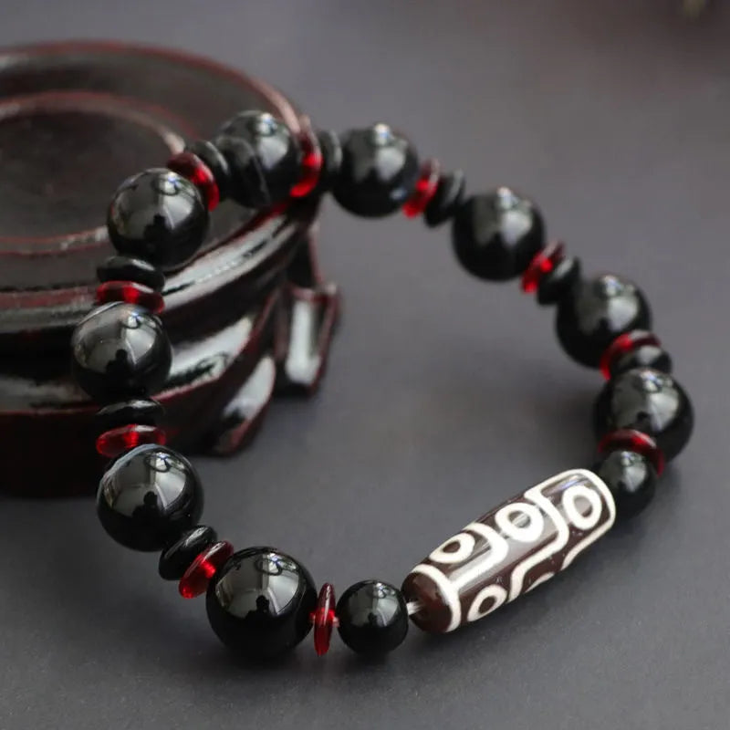 Black agate Dzi bead bracelet with geometric 11mm beads on wrist