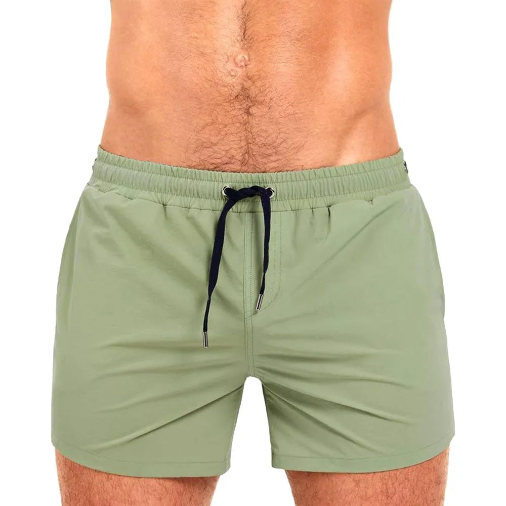 Men's solid colour polyester sports shorts with mesh lining, shown in Army Green, for swimming and fitness.
