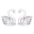 White crystal swan decoration on desktop with red, blue, pink, and violet colour options