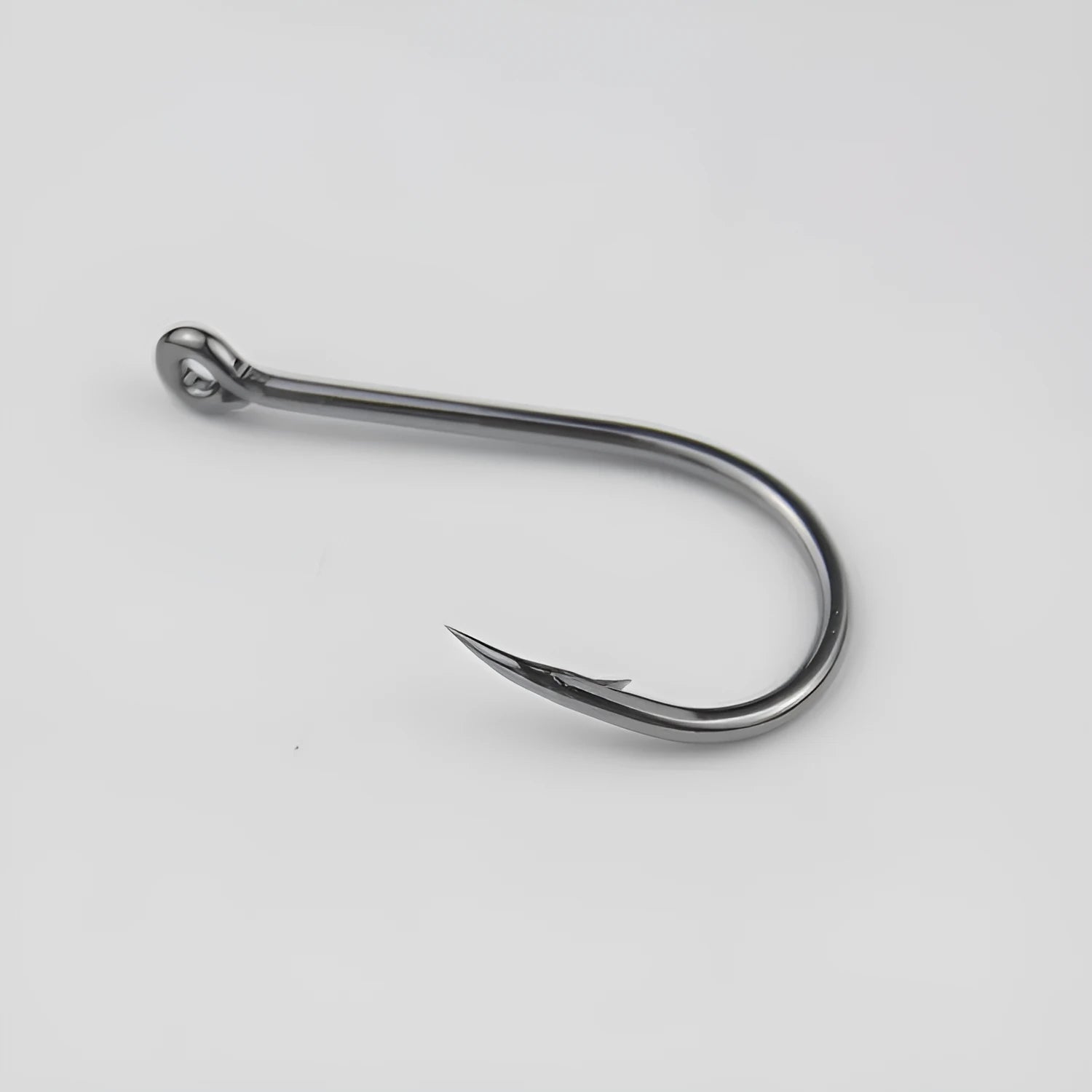 Bulk pack of alloy carbon steel barbed fishing hooks with crooked mouth and hole ring for rock and sea fishing.