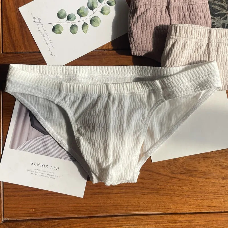 Men's solid colour cotton briefs with a mid waist and triangle design.