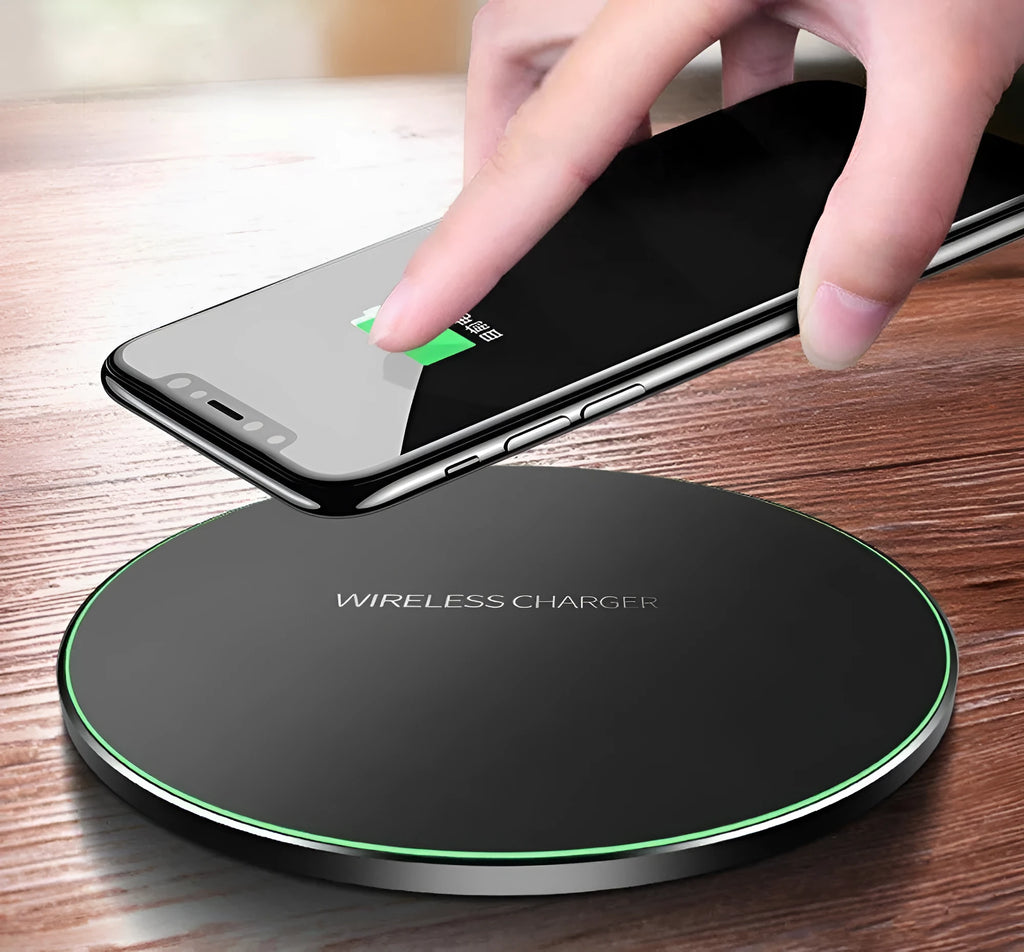 Black ultra-thin square wireless fast charging pad with USB cable on a desk