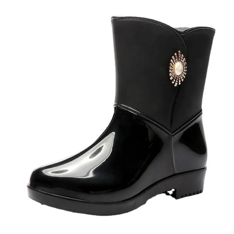 Women's mid-calf rain boot in purple PVC with a non-slip sole and low tube design.