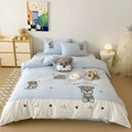 Cartoon Schnauzer embroidered bedding set with quilt cover, sheet, and pillowcases on bed