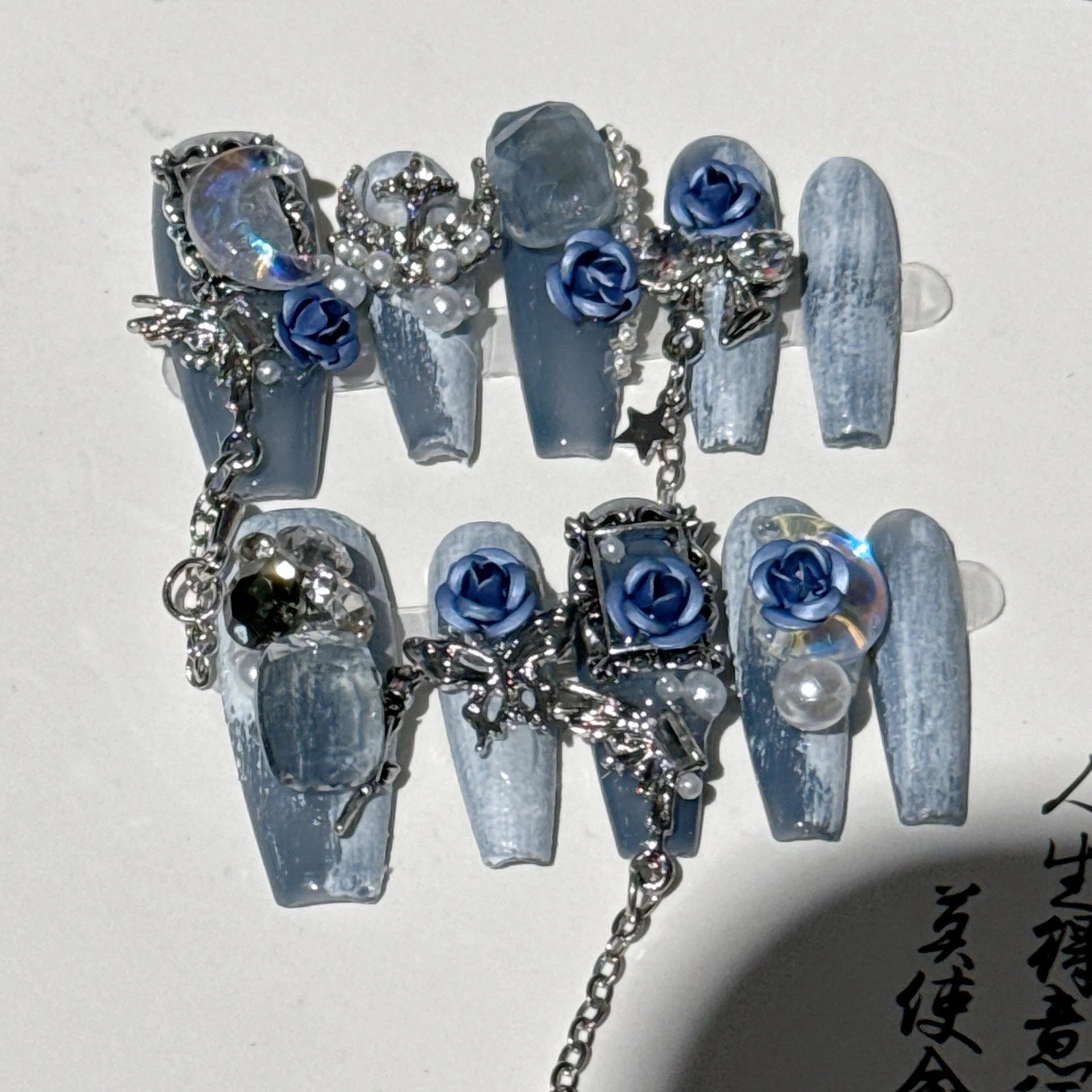 Blue manicure nails with rose tulip floral pattern in plastic armour construction